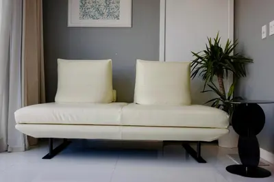 a white couch sitting in a room with a plant at Vista Bliss Retreat-Private Room in Los Angeles