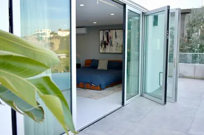 a room with sliding glass doors leading to a bedroom at Vista Bliss Retreat-Private Room in Los Angeles