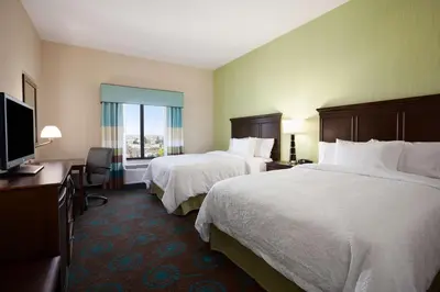 a hotel room with two beds and a flat screen tv at Hampton Inn Los Angeles Int'l Airport/Hawthorne in Los Angeles