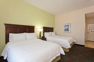 a hotel room with two beds with white sheets at Hampton Inn Los Angeles Int'l Airport/Hawthorne in Los Angeles