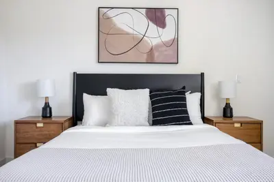a bedroom with a large bed with two night stands at West LA 1br w rooftop gym nr restaurants LAX-1103 in Los Angeles