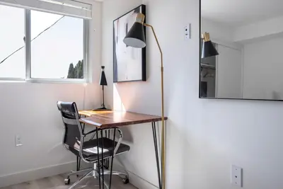 a desk in a room with a lamp and a chair at West LA 1br w rooftop gym nr restaurants LAX-1103 in Los Angeles