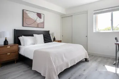 a white bedroom with a large bed and a window at West LA 1br w rooftop gym nr restaurants LAX-1103 in Los Angeles