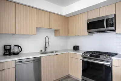 a kitchen with a sink and a stove and a microwave at West LA 1br w rooftop gym nr restaurants LAX-1103 in Los Angeles