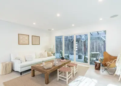 a living room with a white couch and a table at Cali Luxury Dream Hideaway in Woodland Hills
