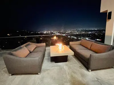 a balcony with two couches and a table with a view at Stunning View Hollywood Hills Guest House in Los Angeles