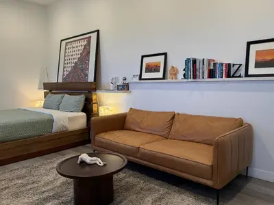 a living room with a couch and a bed at Stunning View Hollywood Hills Guest House in Los Angeles