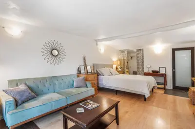 a living room with a couch and a bed at Private Studio City Guest House in Los Angeles