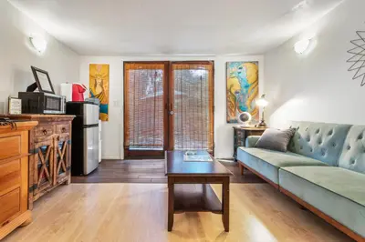 a living room with a couch and a table at Private Studio City Guest House in Los Angeles