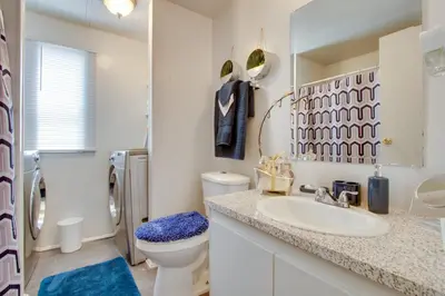 a bathroom with a sink and a toilet and a mirror at Rosamond Vacation Rental with Grill, Near Vineyards! in Rosamond