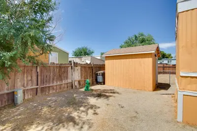 a backyard with a fence and a green fire hydrant at Rosamond Vacation Rental with Grill, Near Vineyards! in Rosamond