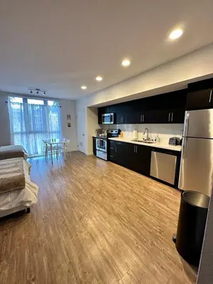 a large living room with a kitchen and a table at Studios Universal 10 min drive FREE parking and WIFI in Los Angeles