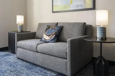 a living room with a couch and two tables at Courtyard by Marriott Los Angeles L.A. LIVE in Los Angeles
