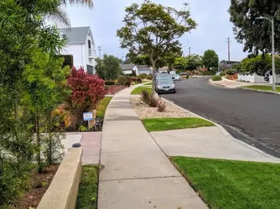 a sidewalk with a car parked on the side of a street at Monthly - Cozy 1 Bed Guest Suite near Venice Beach in Los Angeles