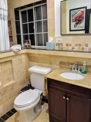 a bathroom with a toilet and a sink and a window at Monthly - Cozy 1 Bed Guest Suite near Venice Beach in Los Angeles