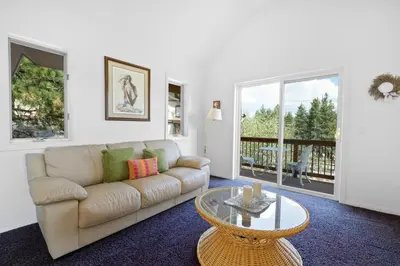 a living room with a couch and a table at Amazing Grace - Zen mountain retreat with lake views in Fawnskin