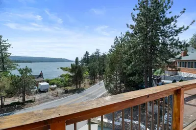 a view from the deck of a house overlooking the water at Amazing Grace - Zen mountain retreat with lake views in Fawnskin