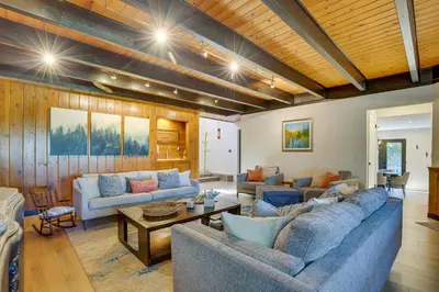 a living room with two couches and a table at 3 Decks, Game Room and Views Lake Arrowhead Home! in Lake Arrowhead