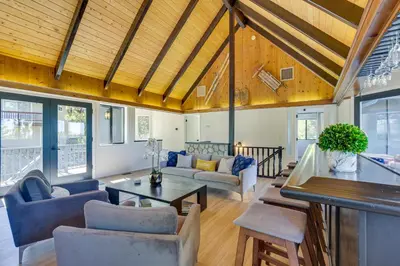 a living room with a table and chairs at 3 Decks, Game Room and Views Lake Arrowhead Home! in Lake Arrowhead