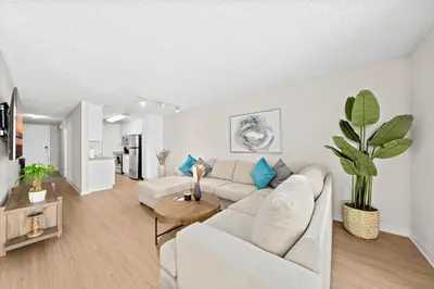 a living room with a white couch and a plant at The Lilas-Ocean view Stay high floor Pool Parking in Los Angeles