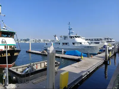 a large white boat is docked at a dock at The Lilas-Ocean view Stay high floor Pool Parking in Los Angeles
