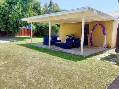 a pavilion with a table and chairs in a yard at Pool Table A C Grill Out Netflix Bikes Yard in Fullerton