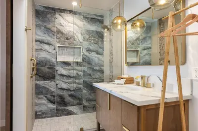 a bathroom with a sink and a shower at California Inn in Anaheim