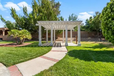 a white gazebo in the middle of a yard at Stylish & Bright ~ Huge Backyard ~ King Beds ~ Pkg in Palmdale