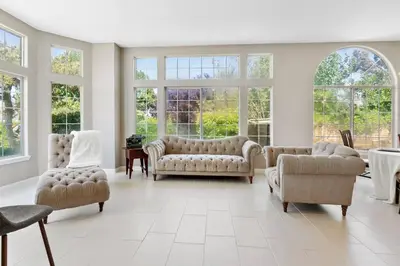 a living room with couches and chairs and windows at Stylish & Bright ~ Huge Backyard ~ King Beds ~ Pkg in Palmdale