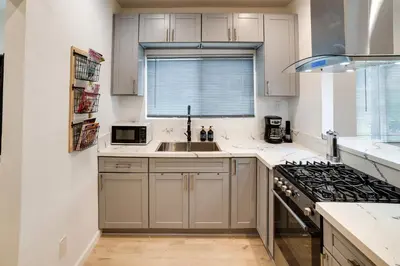 a kitchen with white cabinets and a sink at Pet-Friendly Riverside Vacation Rental with Patio! in Riverside