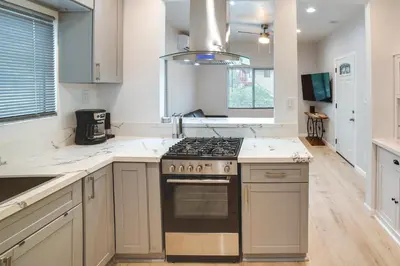 a kitchen with white counters and a stove top oven at Pet-Friendly Riverside Vacation Rental with Patio! in Riverside
