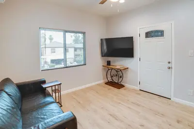 a living room with a couch and a flat screen tv at Pet-Friendly Riverside Vacation Rental with Patio! in Riverside