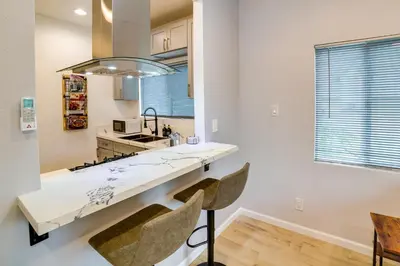 a kitchen with a counter and two chairs in a room at Pet-Friendly Riverside Vacation Rental with Patio! in Riverside