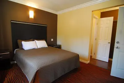 a hotel room with a bed and a door at Studio City Inn - Near Universal Studios Hollywood in Los Angeles