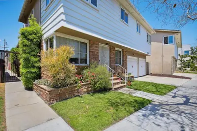 a house with a yard with a driveway at Walk to Retro Row Long Beach Condo in Long Beach