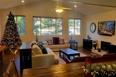 a living room with a christmas tree and a couch at Lake Gregory Escape in Crestline