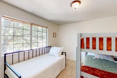 a bedroom with a bunk bed and a window at Lake Gregory Escape in Crestline