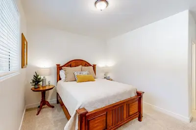 a bedroom with a bed and a small table at Lake Gregory Escape in Crestline