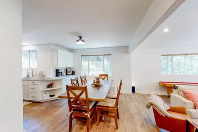 a kitchen and dining room with a table and chairs at Lake Gregory Escape in Crestline
