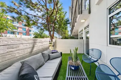 a patio with a couch and chairs and a fence at Beverly Grove Chic City Oasis 2 BR Apt with Den 138 in Los Angeles