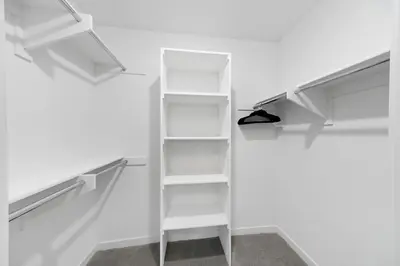 a walk in closet with white shelves at Beverly Grove Chic City Oasis 2 BR Apt with Den 138 in Los Angeles