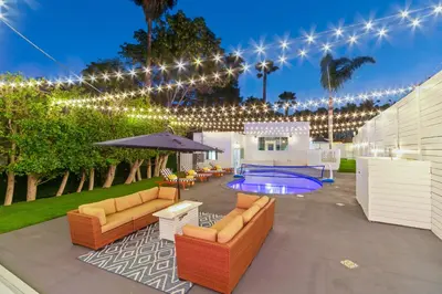 a patio with furniture and a swimming pool with lights at Universal Studios Villa with Pool & Guesthouse in Los Angeles