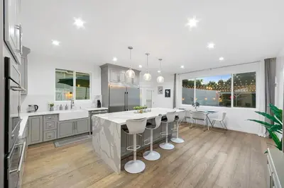 a kitchen with a large island with bar stools at Universal Studios Villa with Pool & Guesthouse in Los Angeles