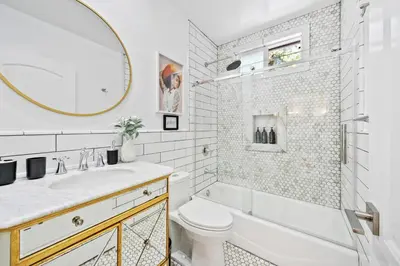 a bathroom with a sink toilet and a mirror at Universal Studios Villa with Pool & Guesthouse in Los Angeles
