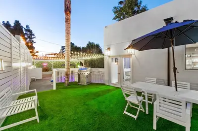 a patio with a table and chairs and an umbrella at Universal Studios Villa with Pool & Guesthouse in Los Angeles