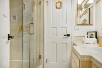 a bathroom with a shower and a glass door at Beverly Tree House in Los Angeles
