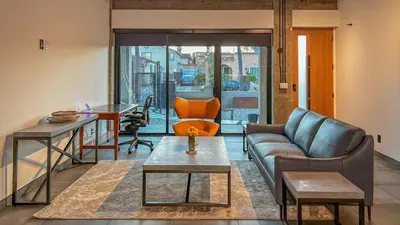 a living room with a couch and a table at NEW Luxury Concrete Home Just Minutes from the Beach in Long Beach