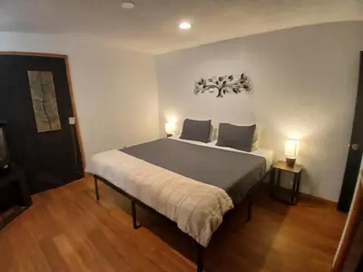 a bedroom with a bed with two lights on the wall at Lakefront Escape in Big Bear Lake