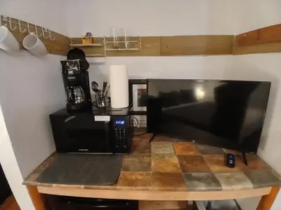 a microwave sitting on a table next to a coffee maker at Lakefront Escape in Big Bear Lake