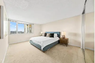 a white bedroom with a bed and a window at Smoky Quartz -Marina View Spacious 3BR near Yacht Club in Los Angeles